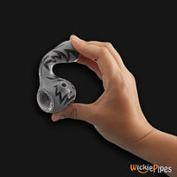 Thumbnail for EYCE Oraflex Switchback Spoon 4.25-Inch Indestructible Silicone Smoking Pipe Smoke Black persons hand flexing pipe showing side carb